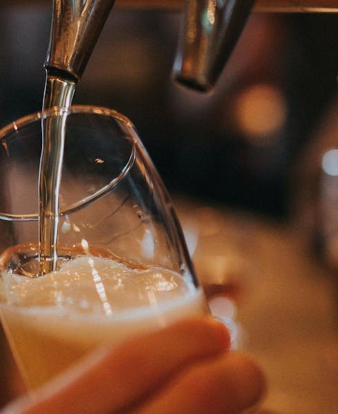 a pint of beer being poured
